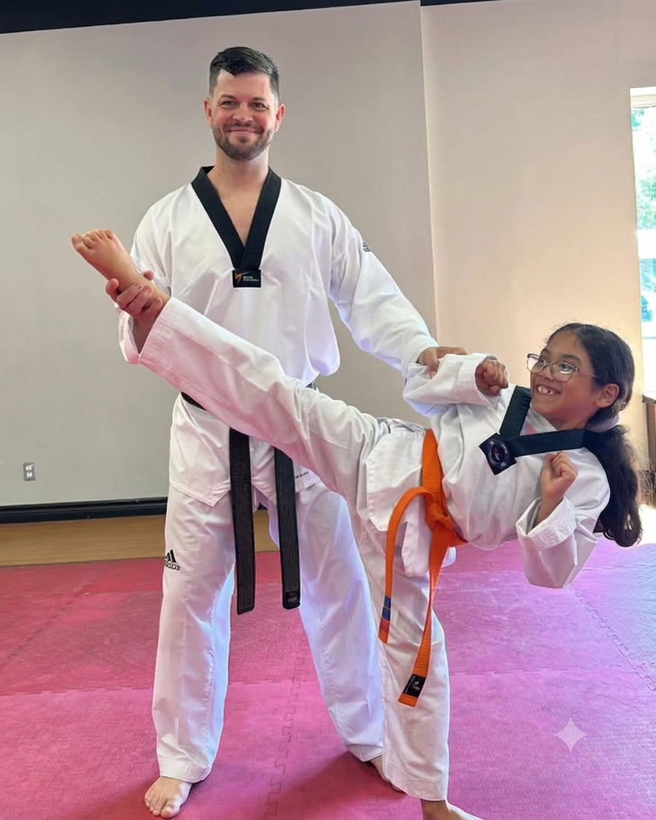 Instructor giving a young student a high-five at Ronny's Taekwondo